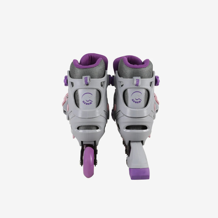 Pair of gray and purple roller skates on a white background