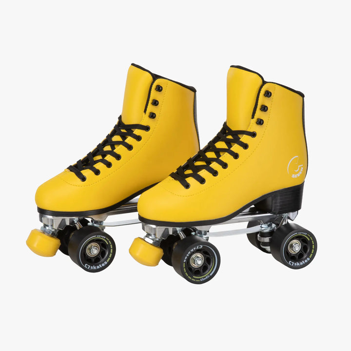 Yellow roller skates with black laces on a white background