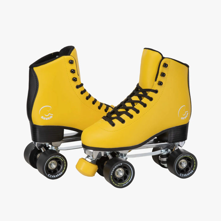 Yellow roller skates with black laces on a white background