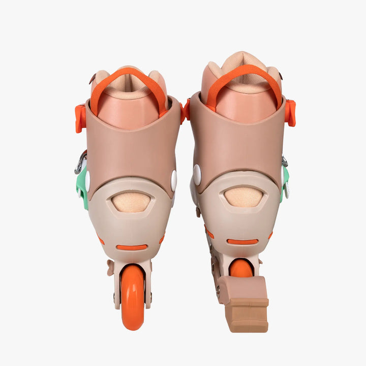 Pair of beige and orange roller skates on a white background