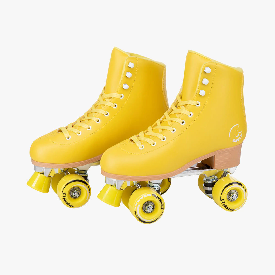 Pair of yellow roller skates on a white background