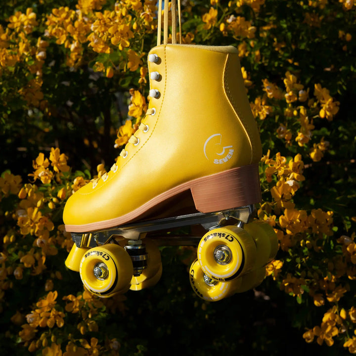 Yellow roller skate with visible brand logo against a floral background
