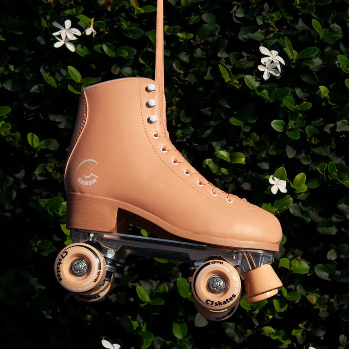 Tan roller skate on a green leafy background