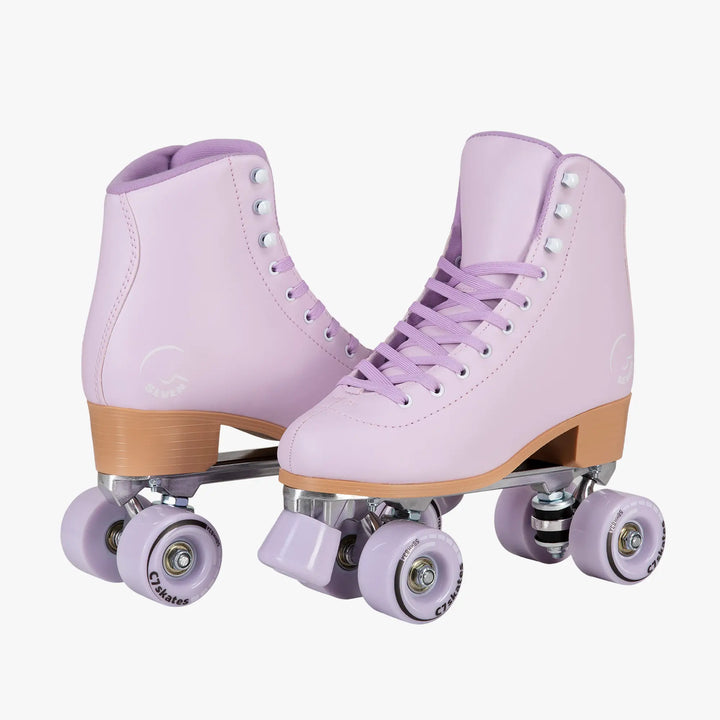 Pair of lavender roller skates with brown soles on a white background