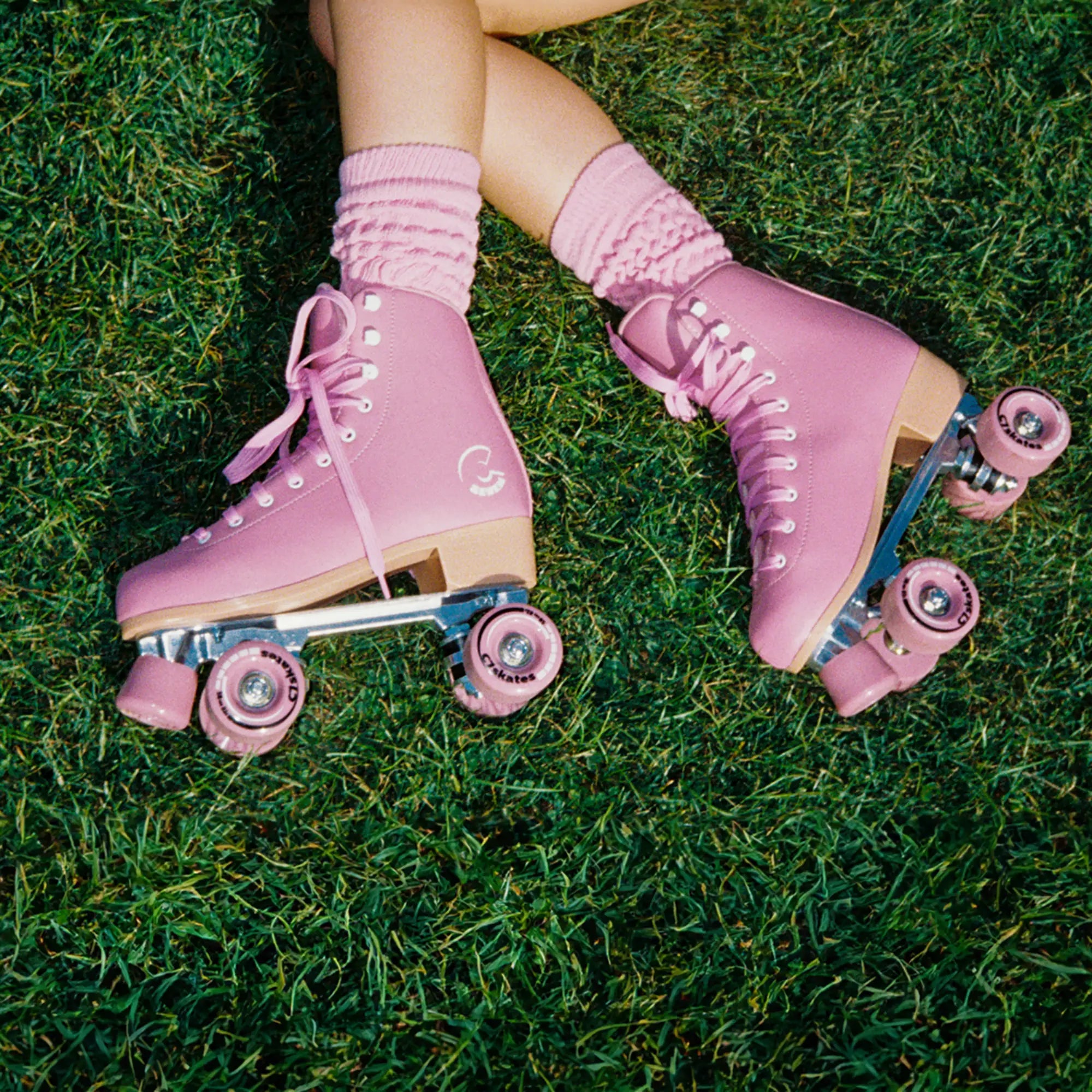 Pink roller skates on grass