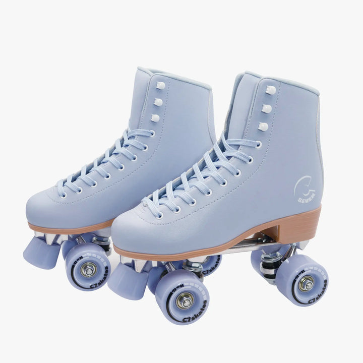Pair of light blue roller skates with brown soles on a white background