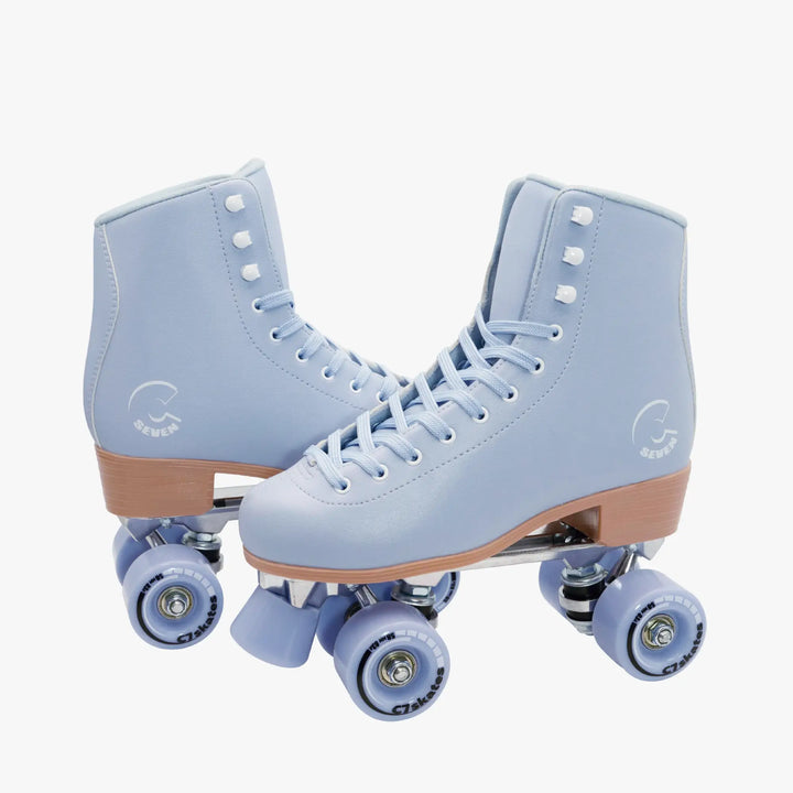 Pair of light blue roller skates with brown accents on a white background