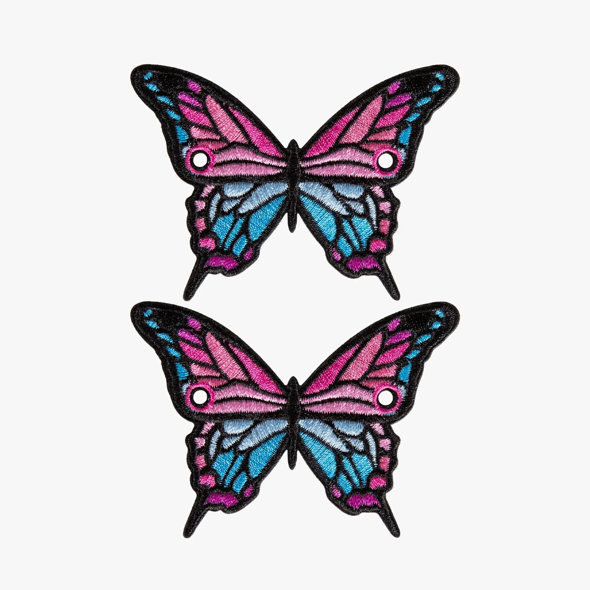 Two butterfly-shaped laces charms with pink and blue wings on a white background
