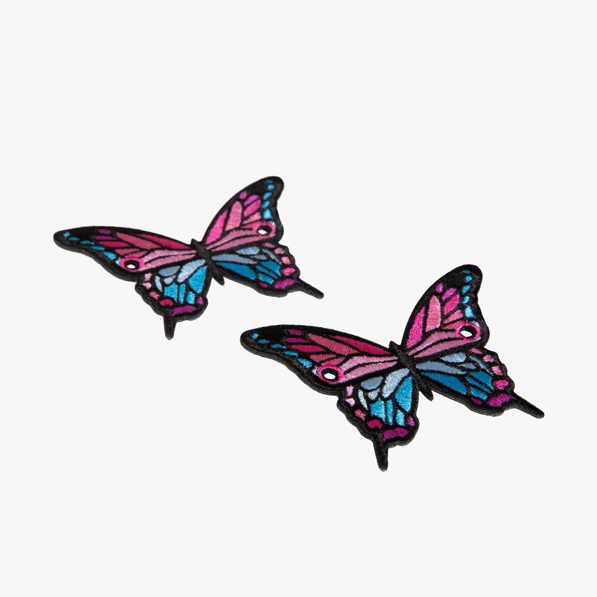 Two colorful butterfly-shaped charms on a white background