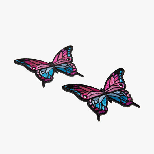 Two colorful butterfly-shaped charms on a white background
