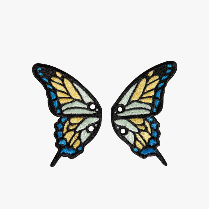 Pair of butterfly wing charms on a white background
