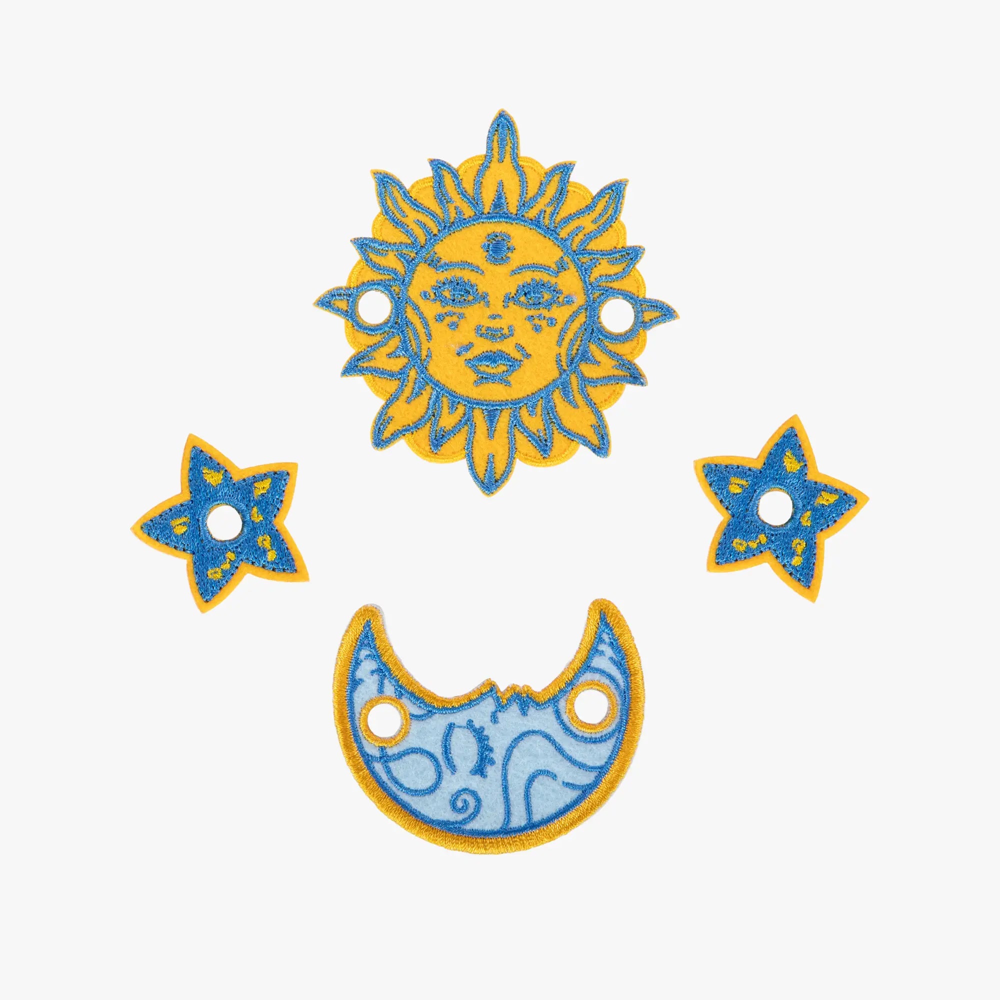 Decorative sun, moon, and star charms on a white background