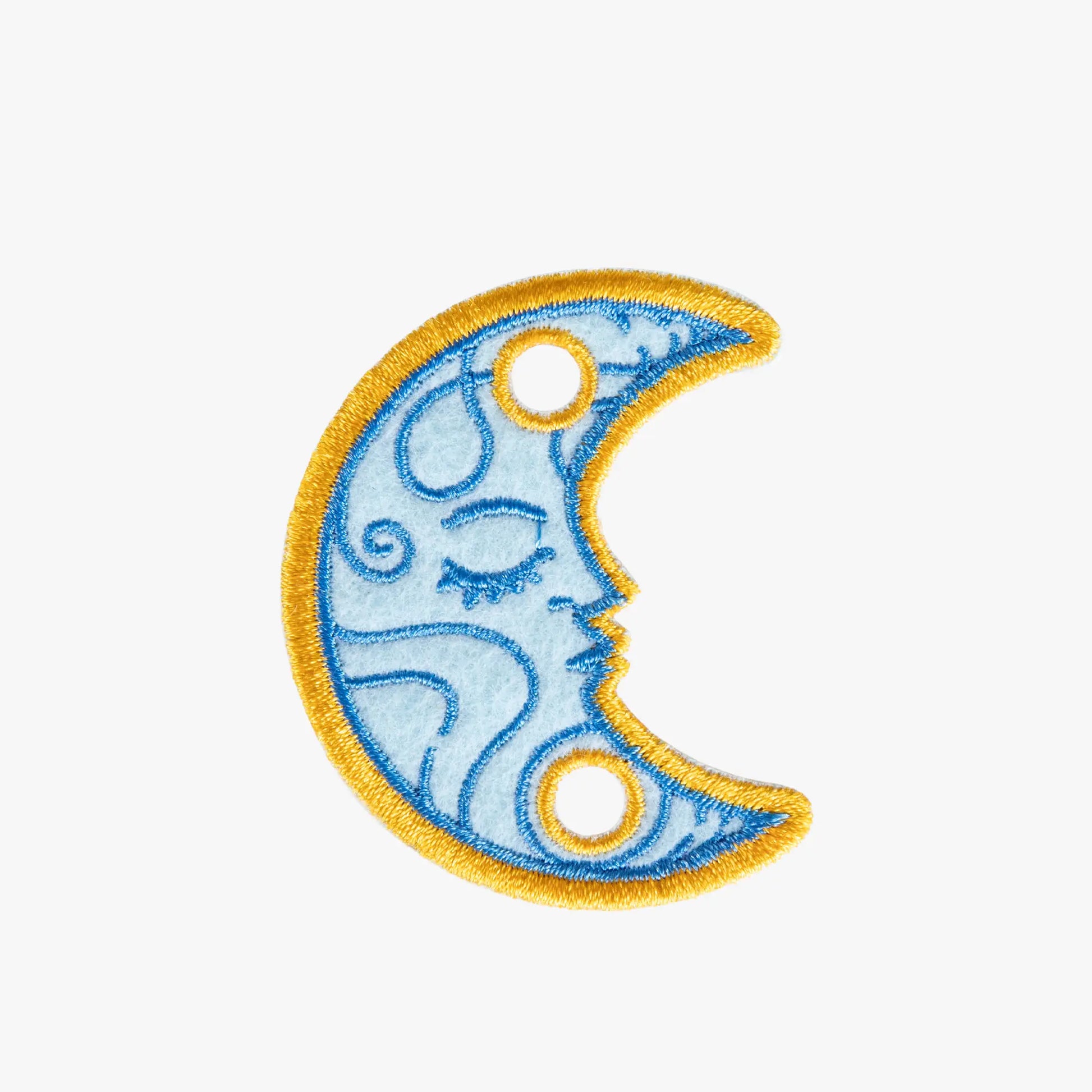 Decorative charm with a blue crescent moon design on a white background
