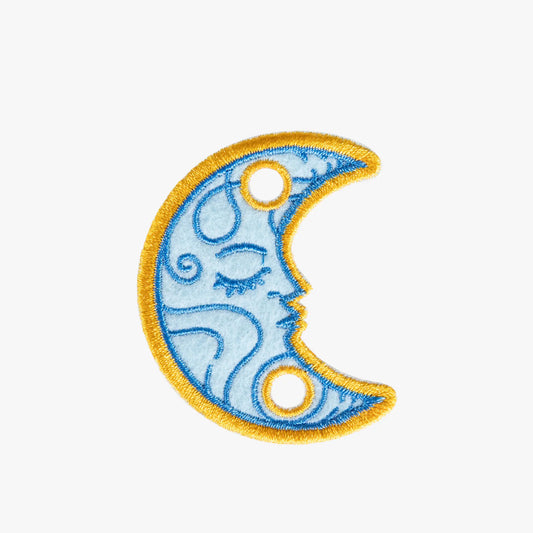 Decorative charm with a blue crescent moon design on a white background