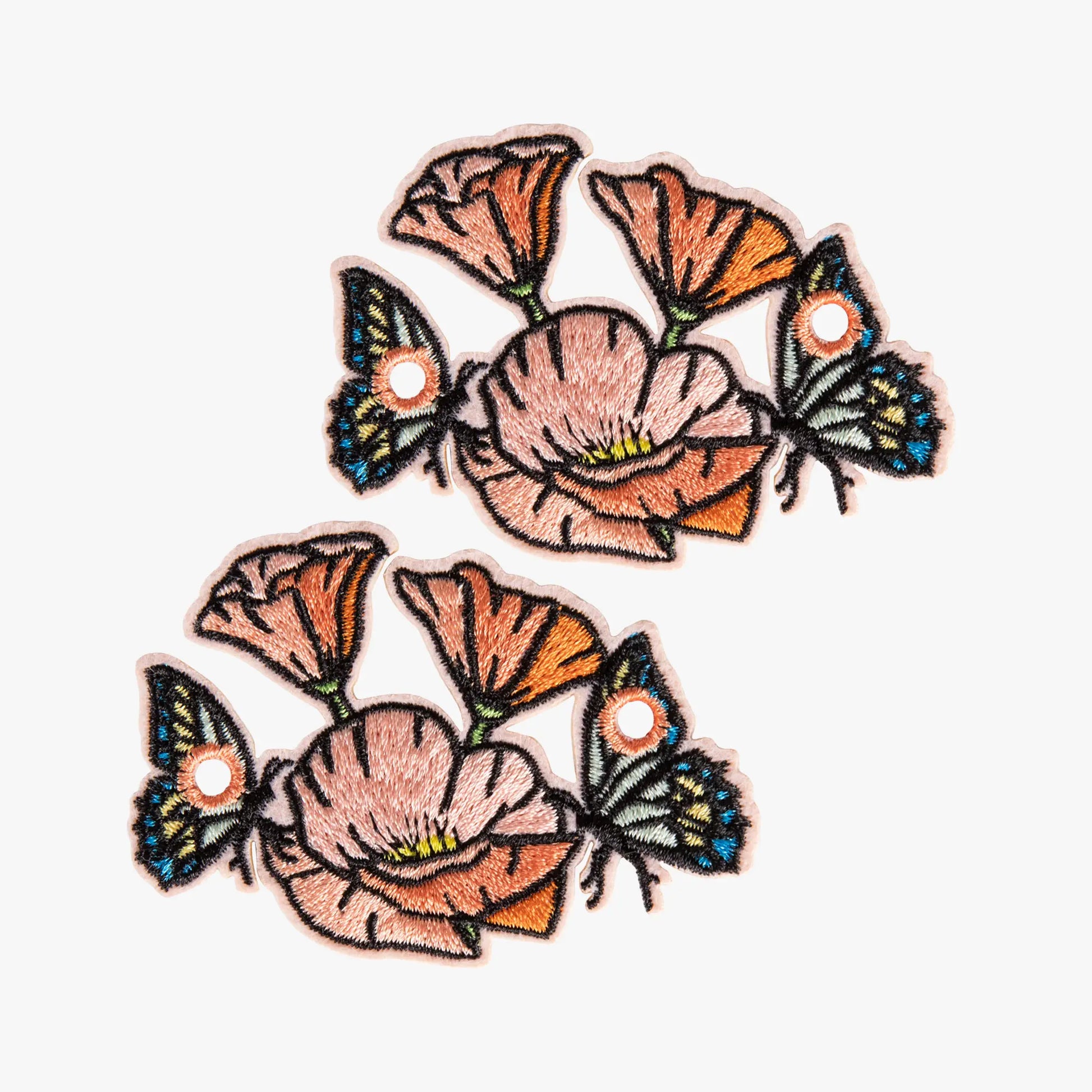 Two floral and butterfly charm on a white background