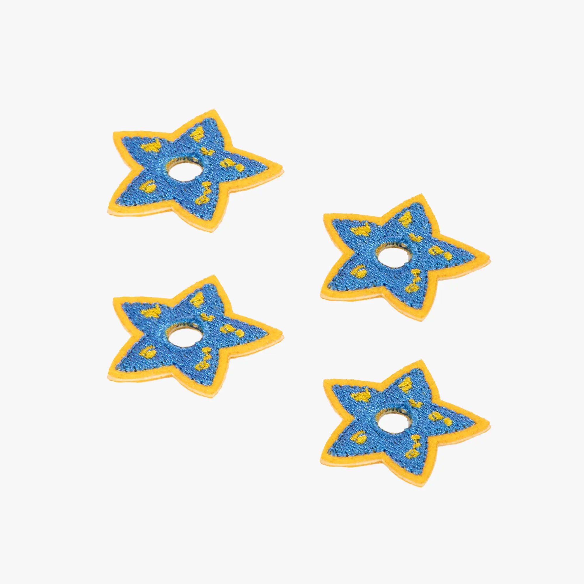 Four blue star-shaped charms with yellow accents on a white background