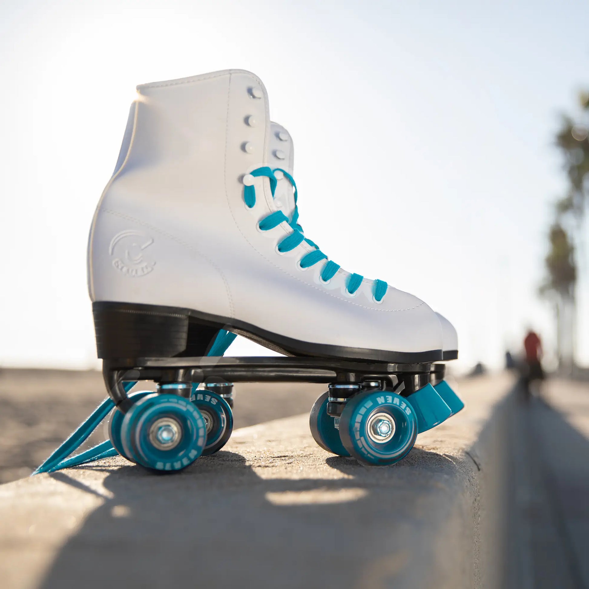 White roller skate with blue wheels on a concrete surface