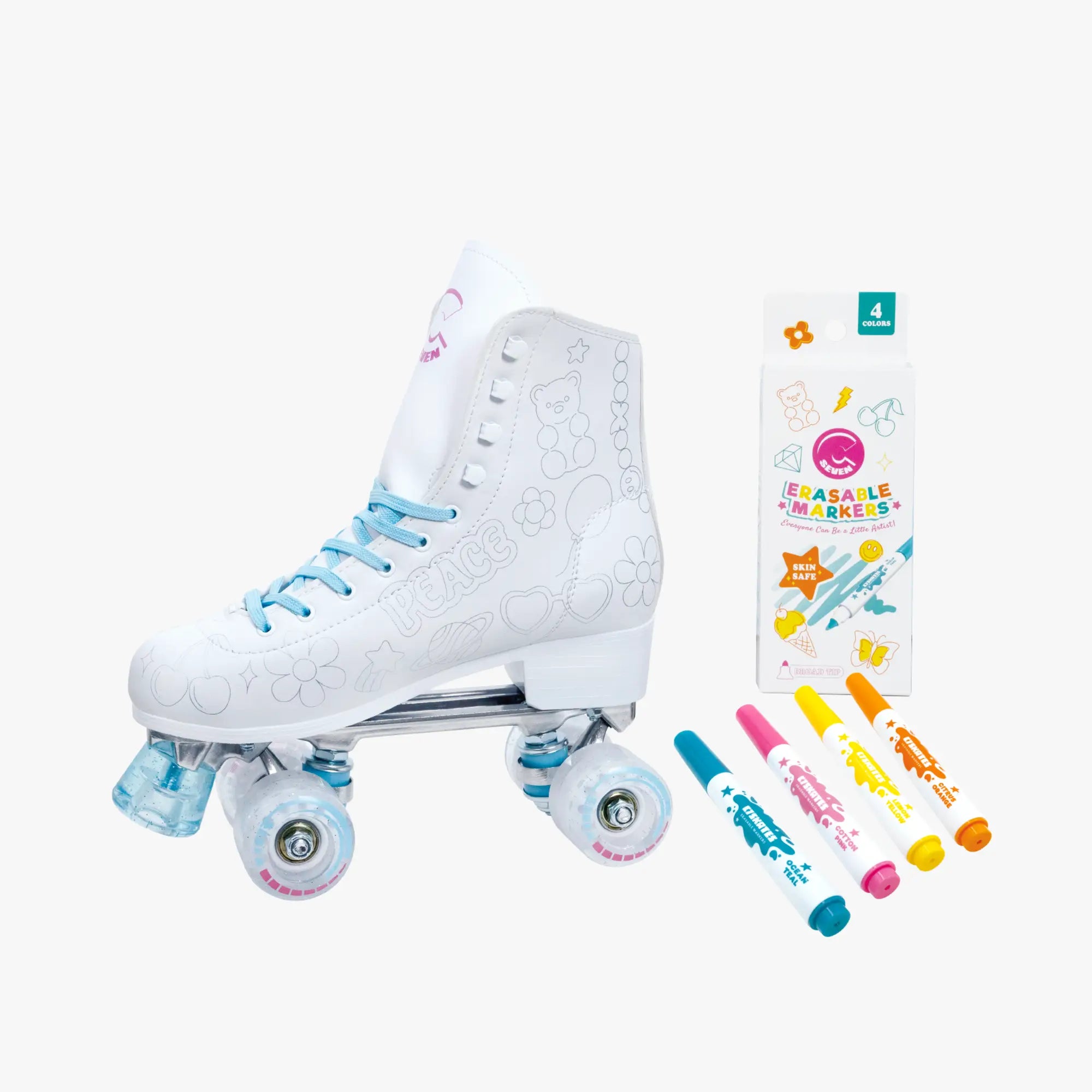 White roller skates with blue laces and a package of colorful markers on a white background
