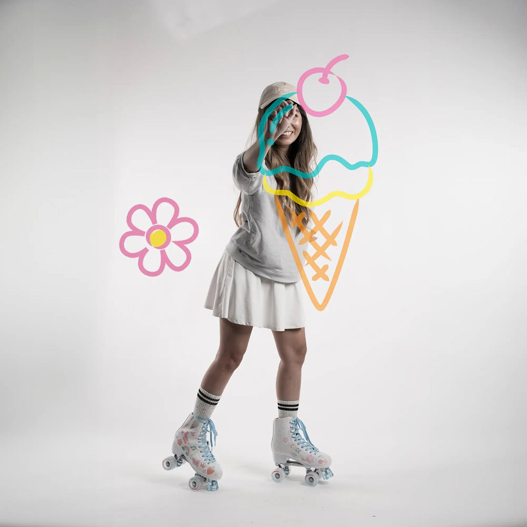 Person wearing roller skates with colorful ice cream cone and flower graphics on a white background