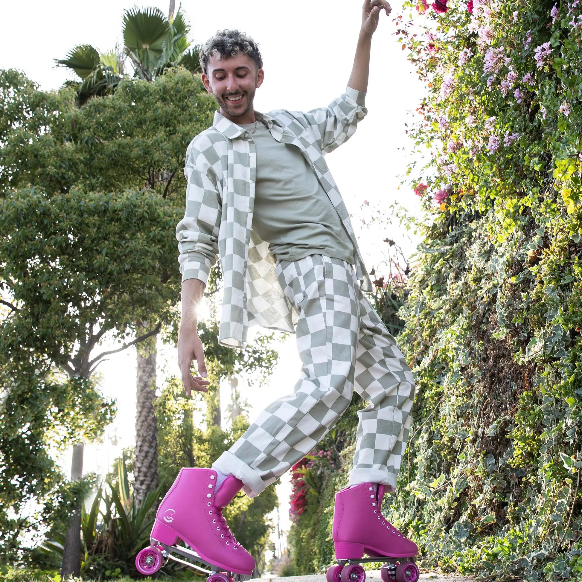 Person rollerblading in a park with greenery and flowers in the background