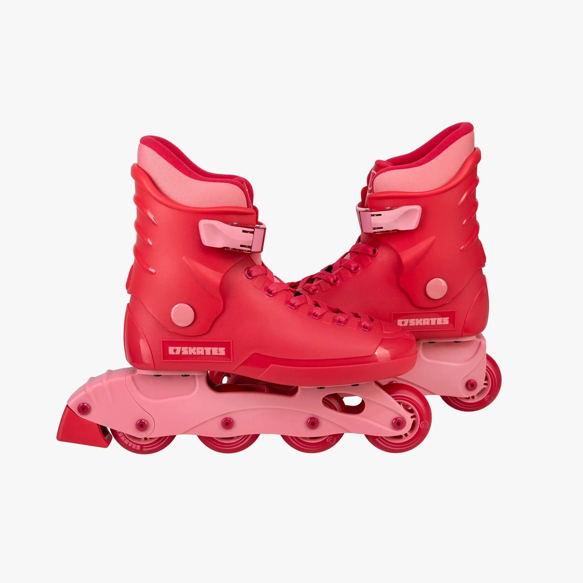 Red roller skates with pink accents on a white background