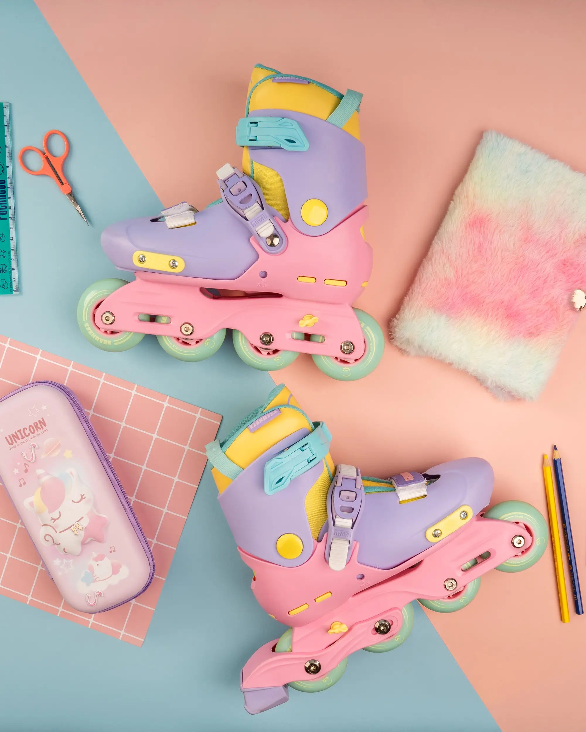 Colorful inline skates on a colorful background with stationery items.