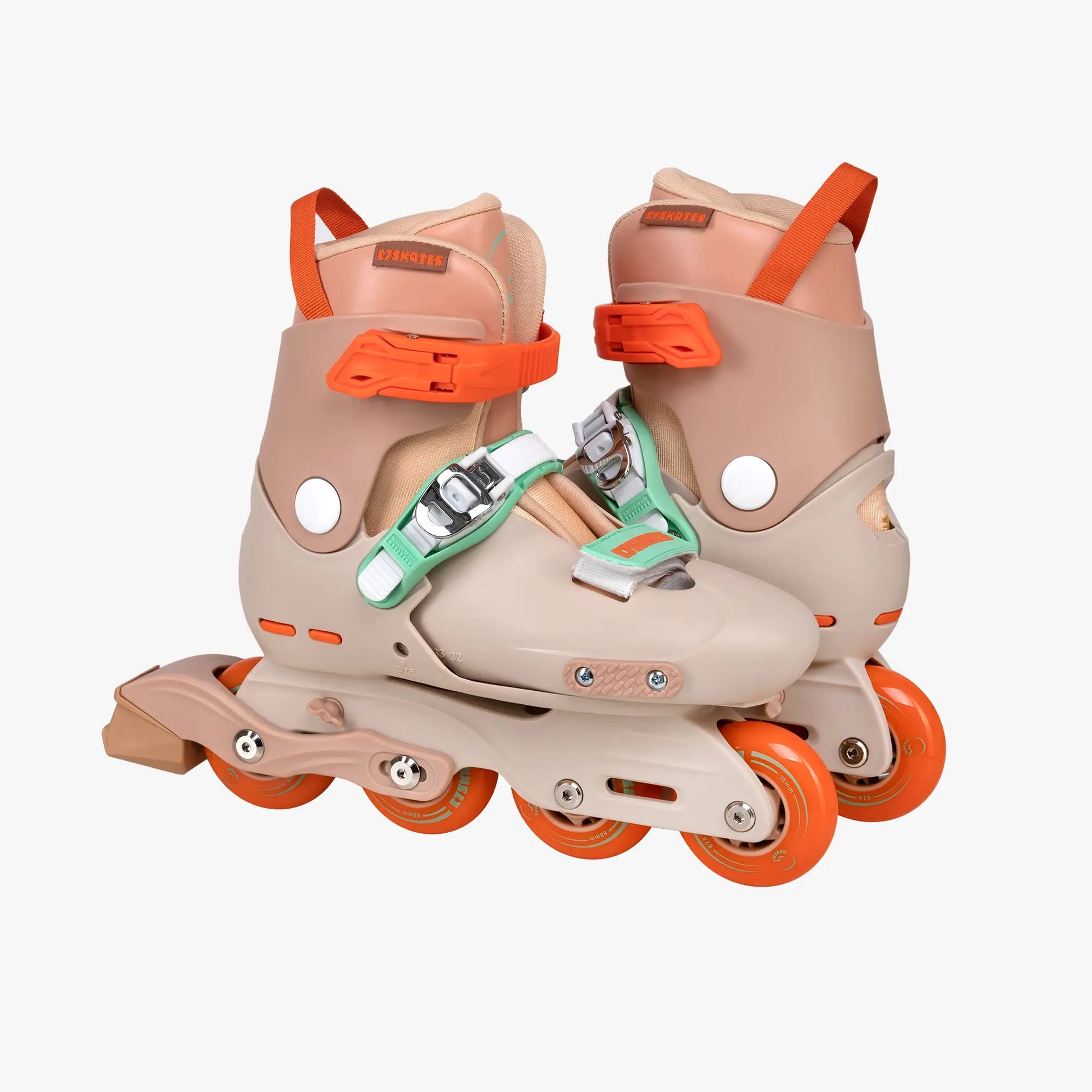 Pair of beige and orange inline skates on a white background