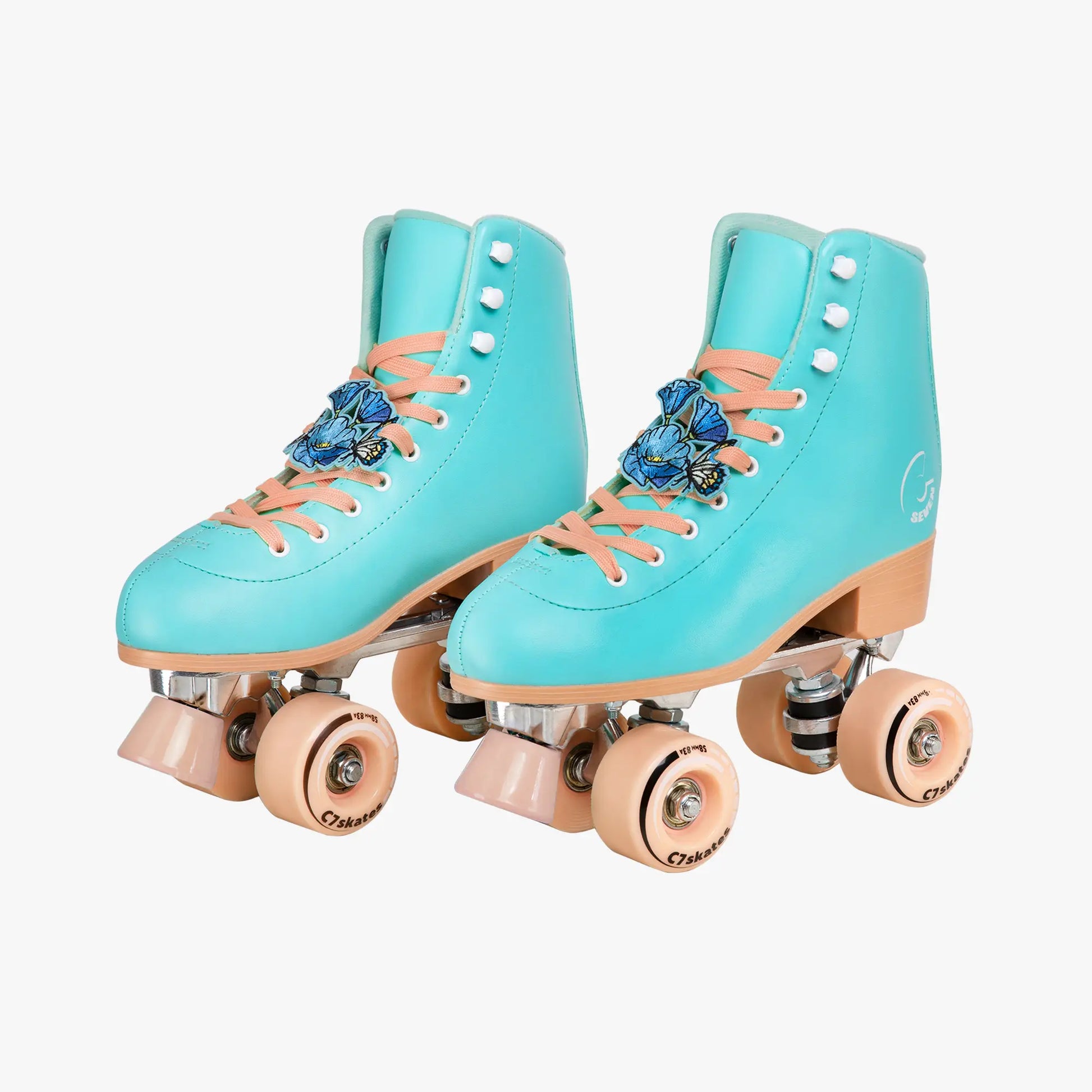 Pair of turquoise roller skates with pink laces and wheels on a white background