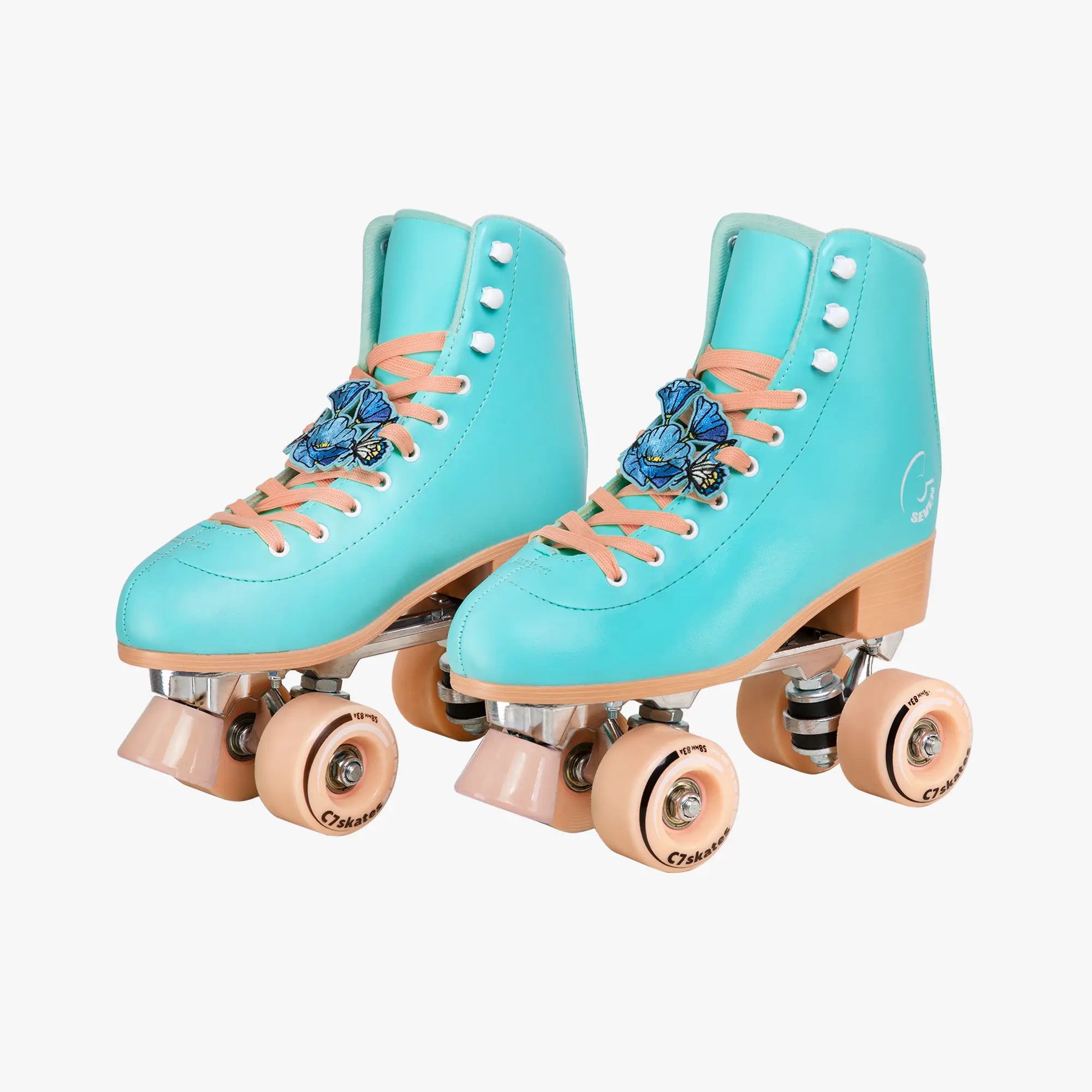 Pair of turquoise roller skates with pink laces and wheels on a white background