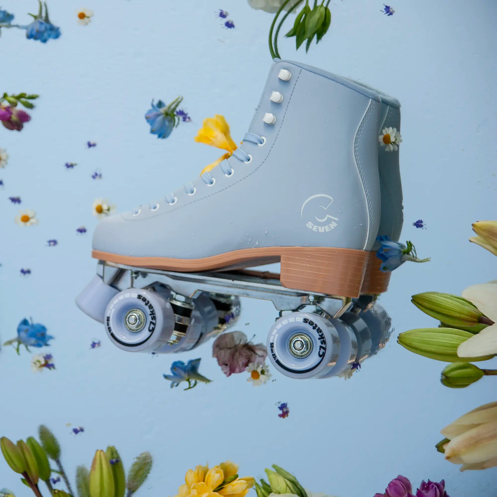 Light blue roller skate with brown accents on a floral background