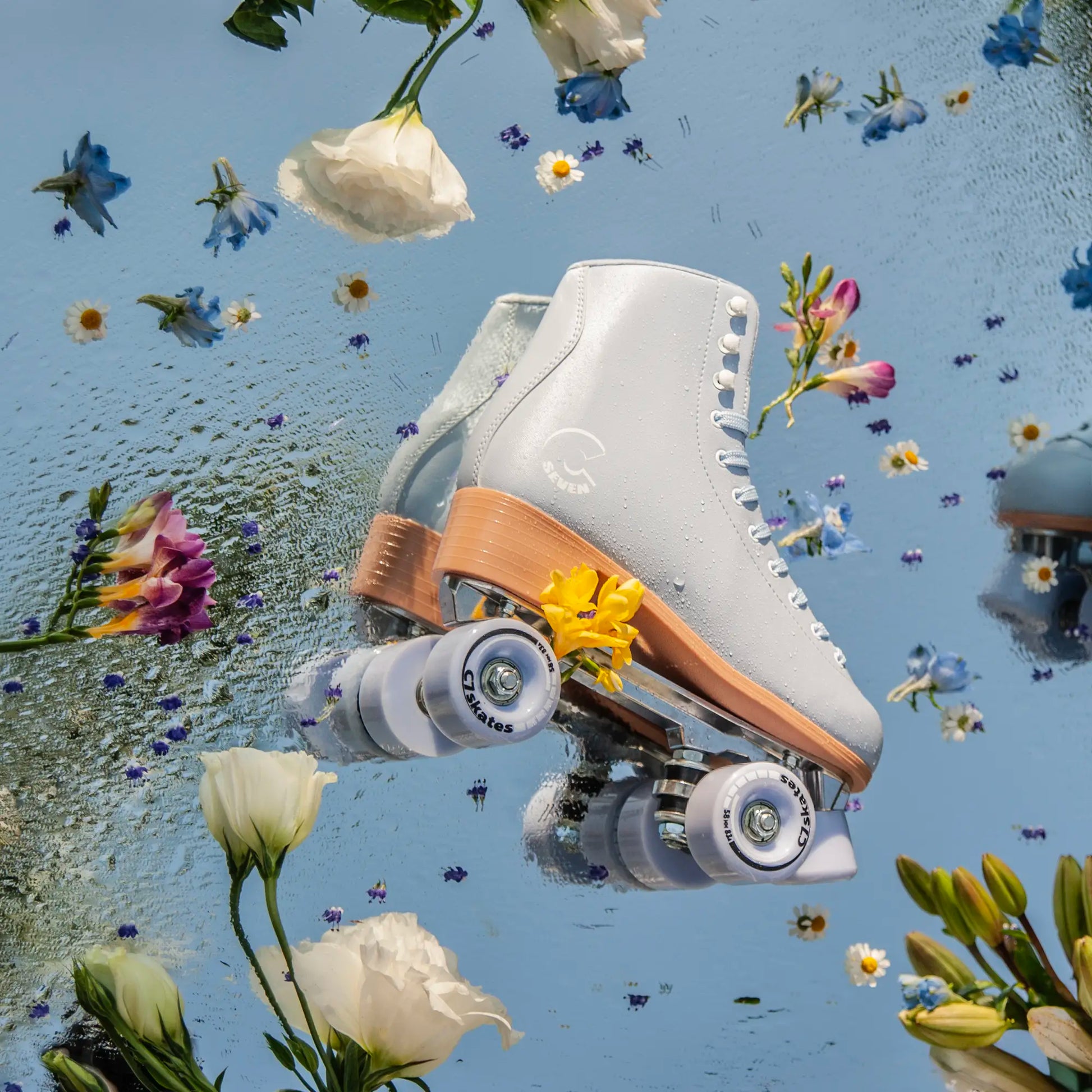 White roller skate with brown accents on a blue background with flowers