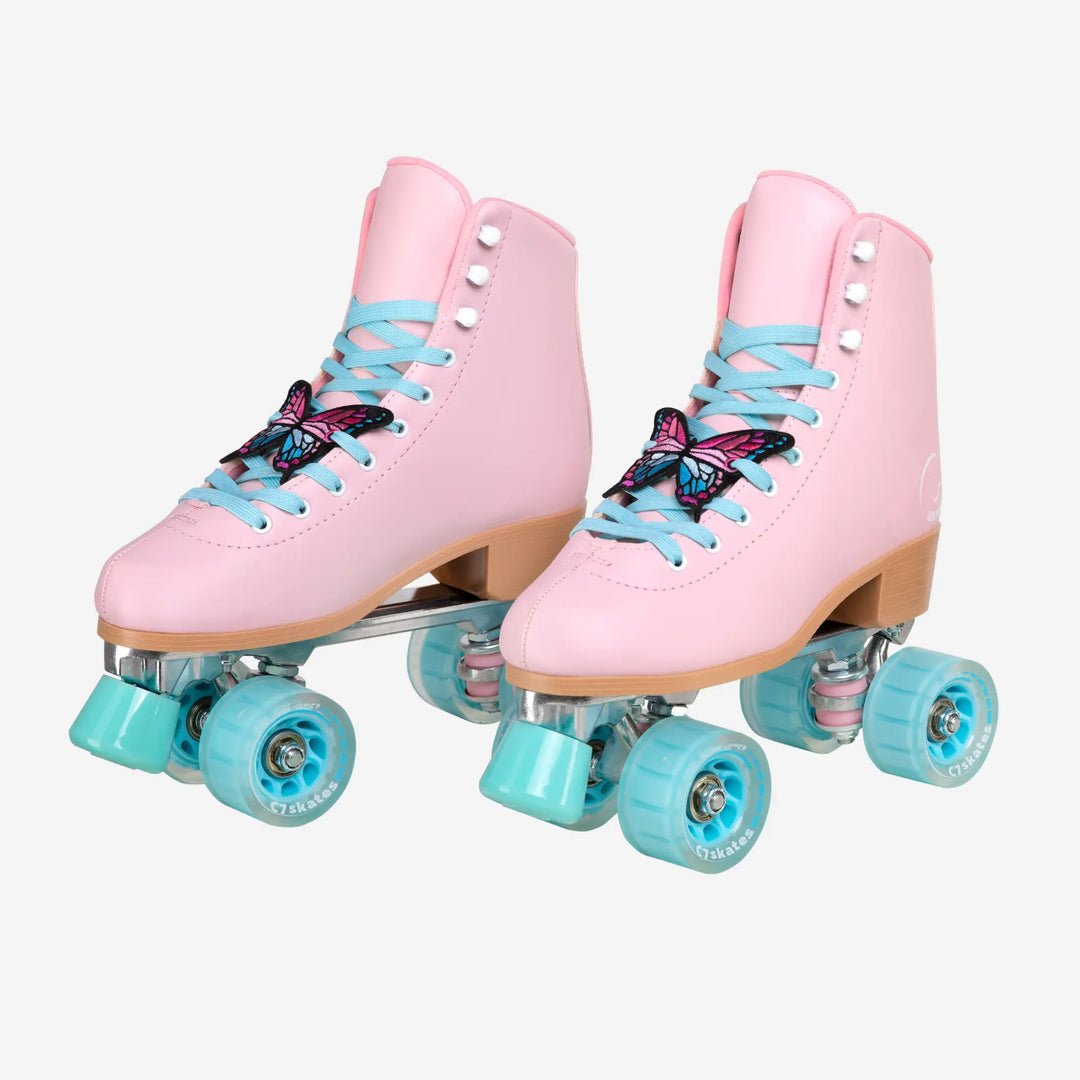 Pink roller skates with blue laces and turquoise wheels on a white background