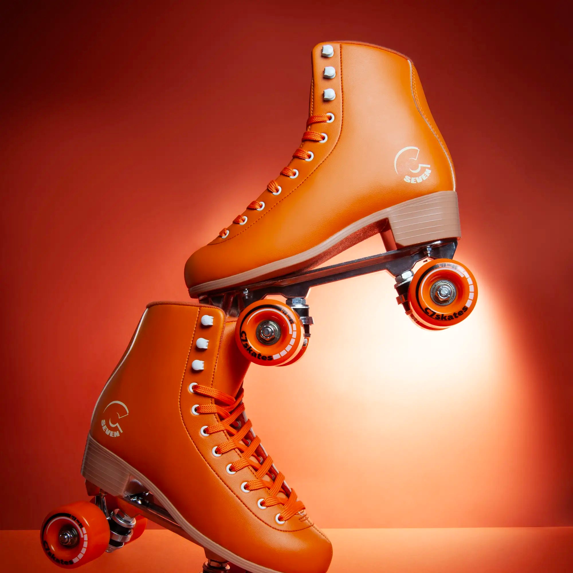 Pair of orange roller skates featuring the brand 'C7Skates' on an orange background