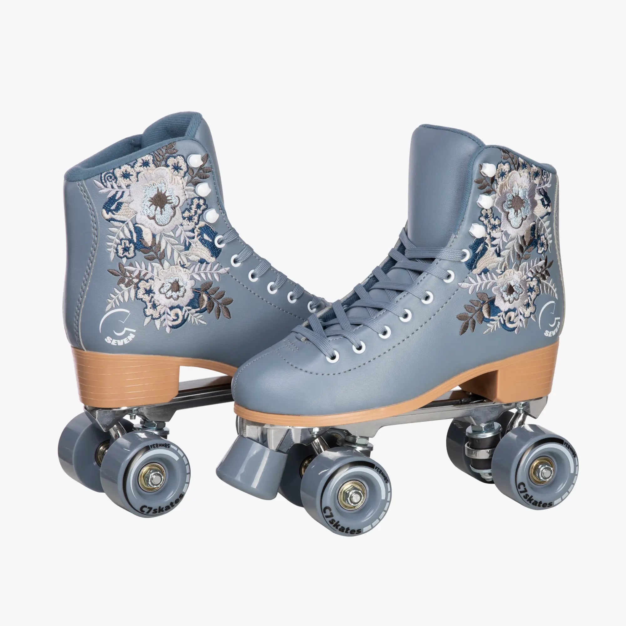 Pair of gray roller skates with floral designs on a white background
