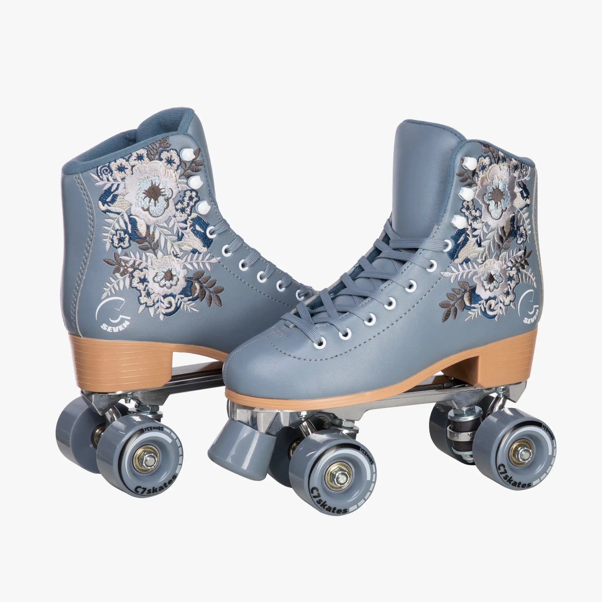 Pair of gray roller skates with floral designs on a white background