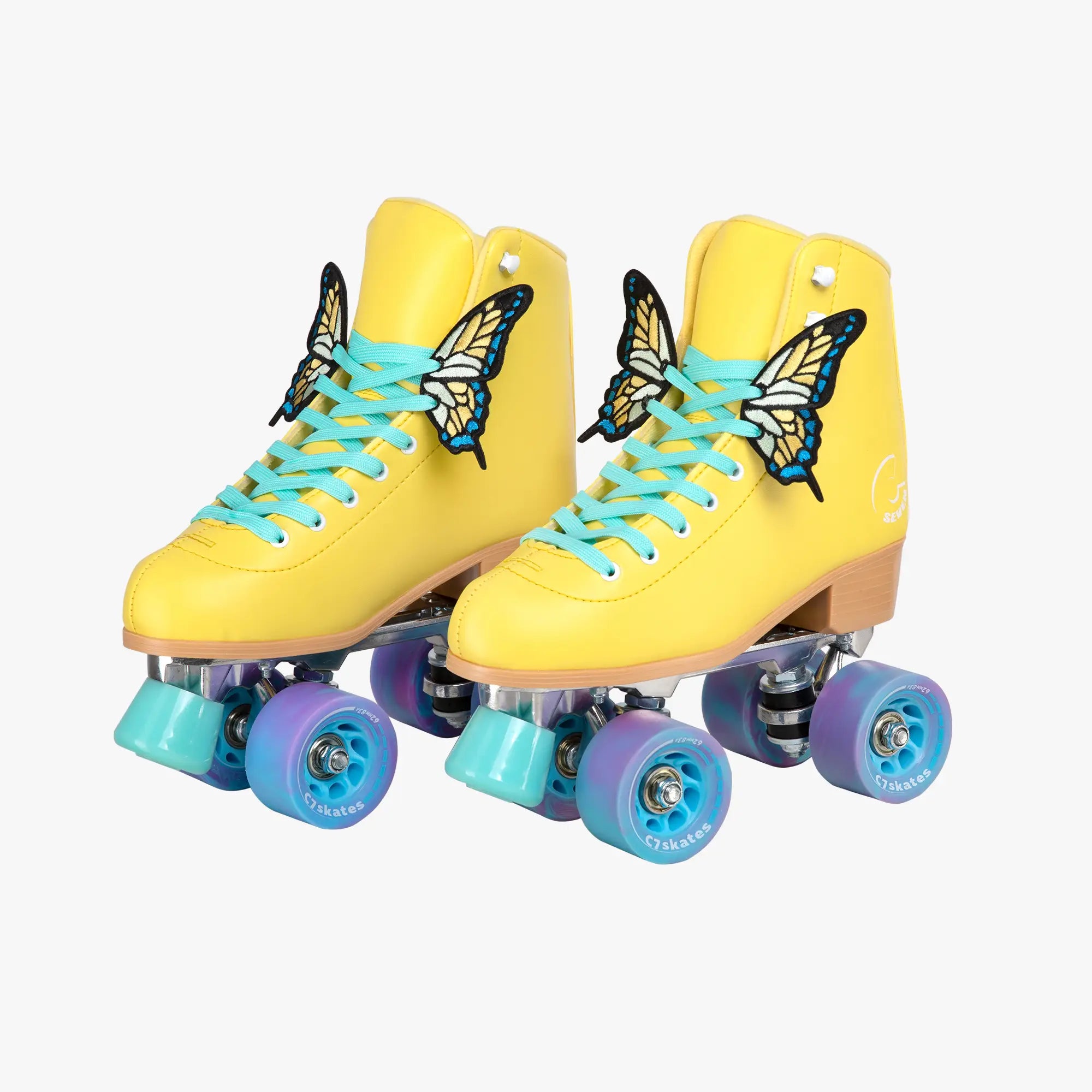 Yellow roller skates with blue laces and wheels on a white background