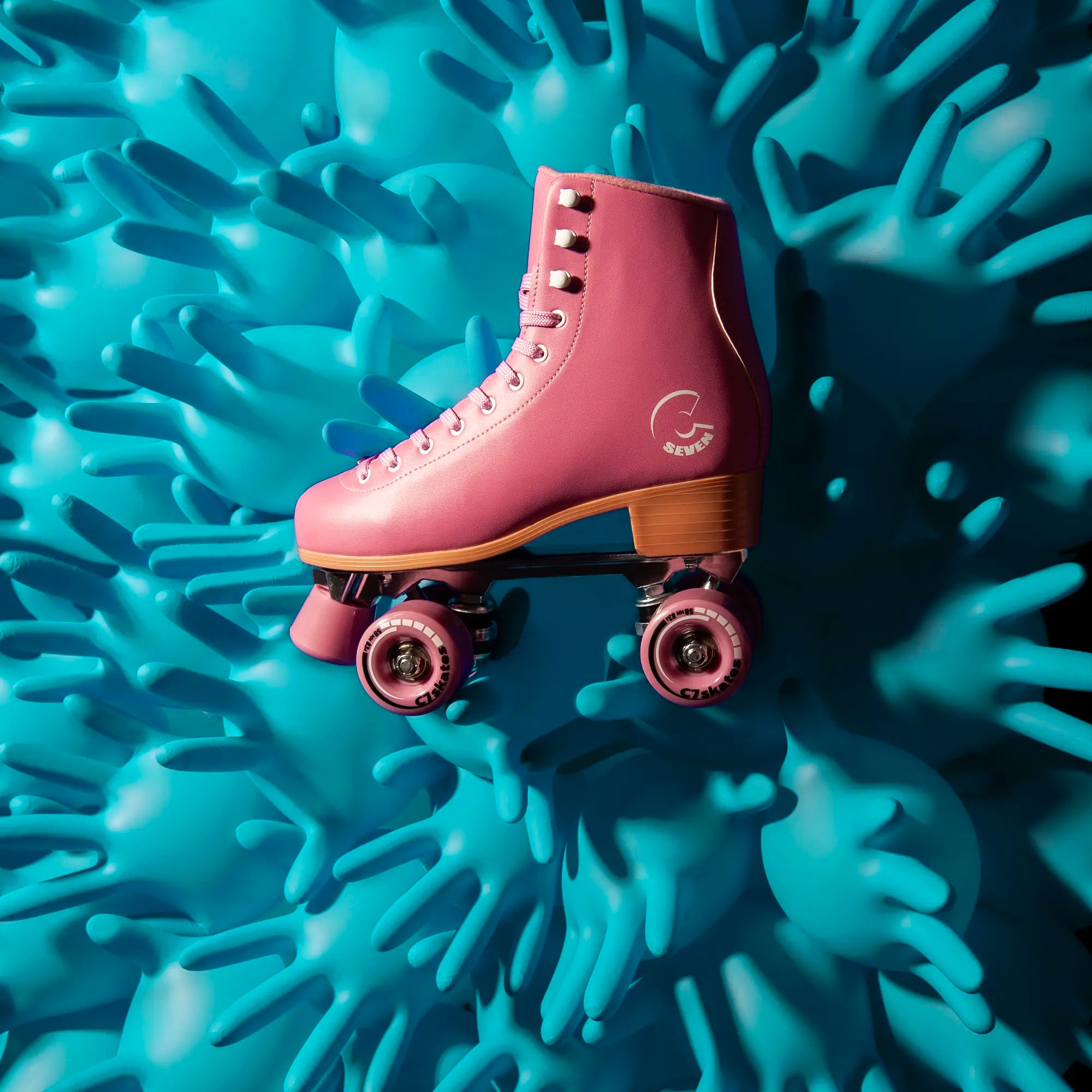 Pink roller skate on a textured blue surface