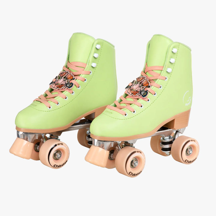 Pair of light green roller skates with peach laces on a white background