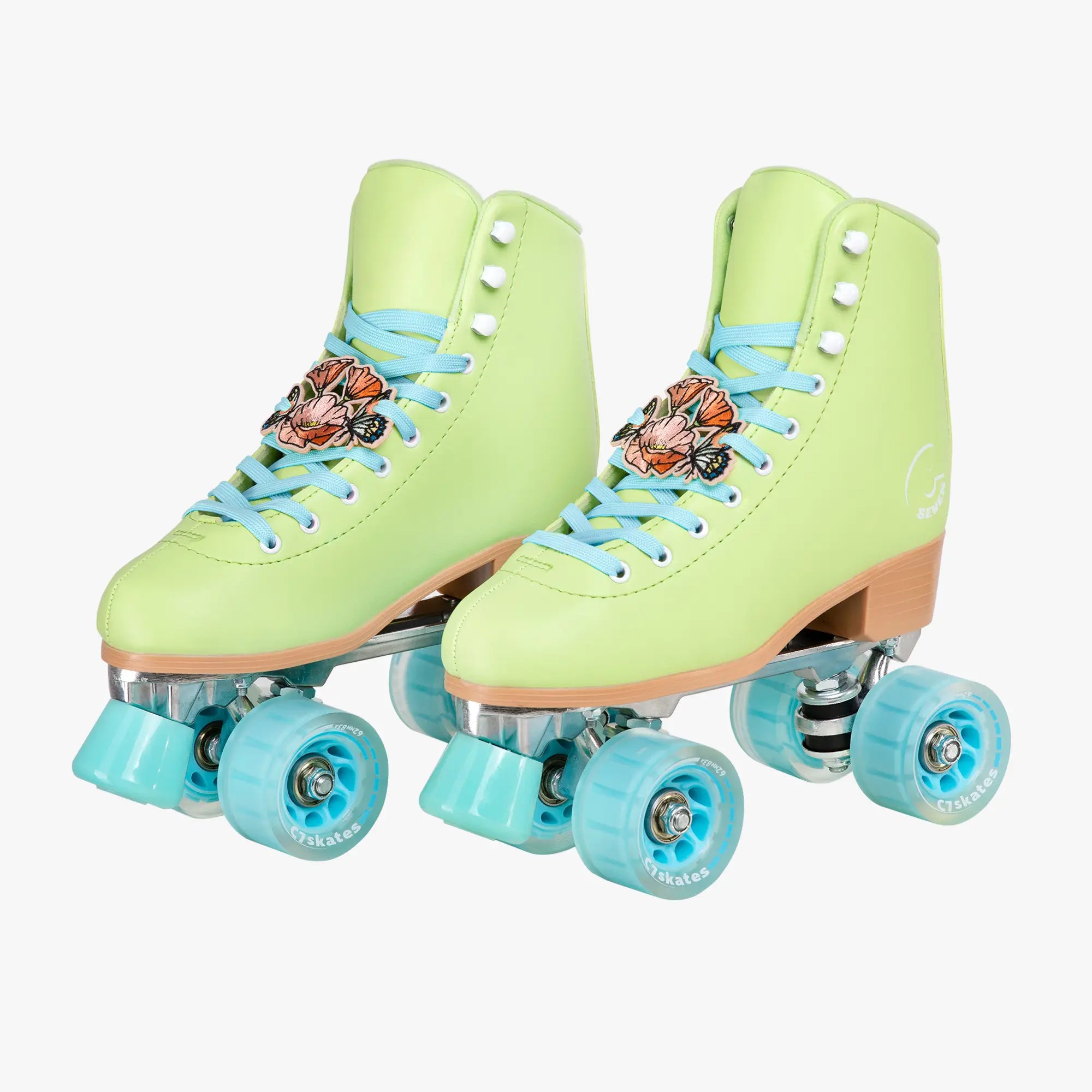 Pair of light green roller skates with blue laces and wheels on a white background
