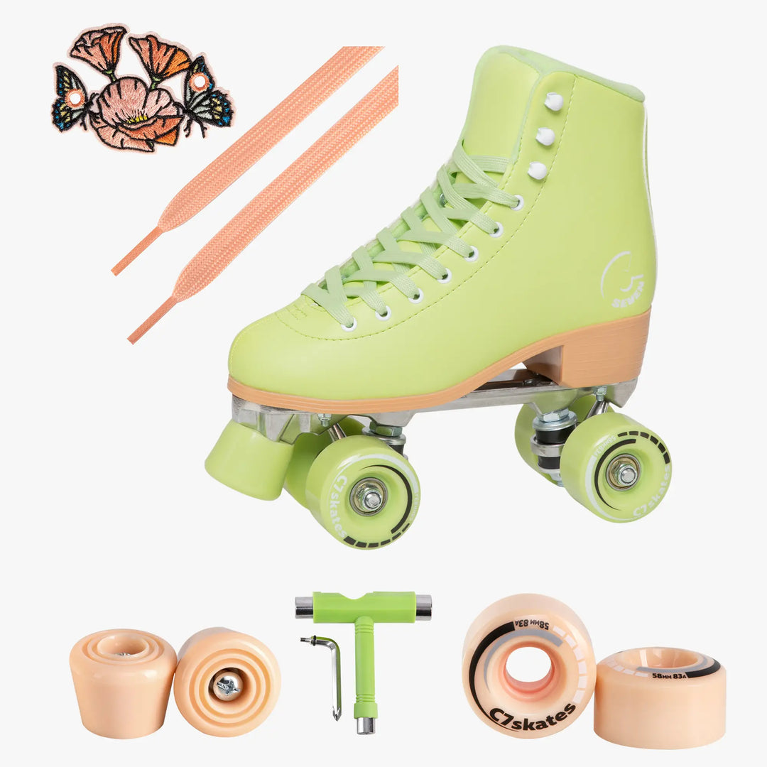 Light green roller skates with peach accents, including wheels and tools on a white background.