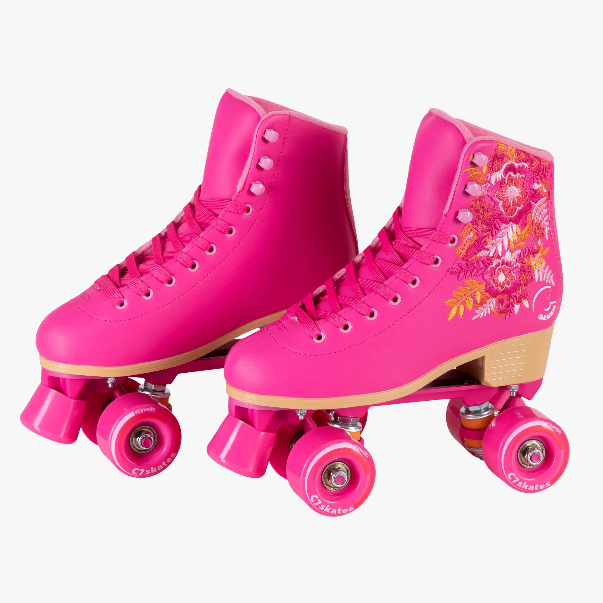 Pink roller skates with floral design on a white background