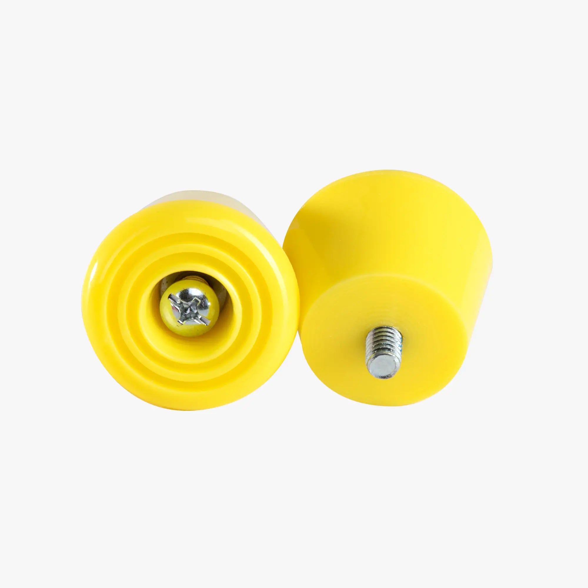 Two yellow rubber stoppers with metal screws on a white background