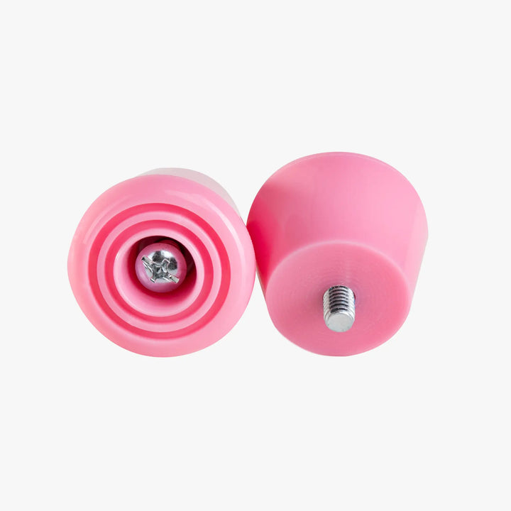 Two pink stoppers with metallic centers on a white background