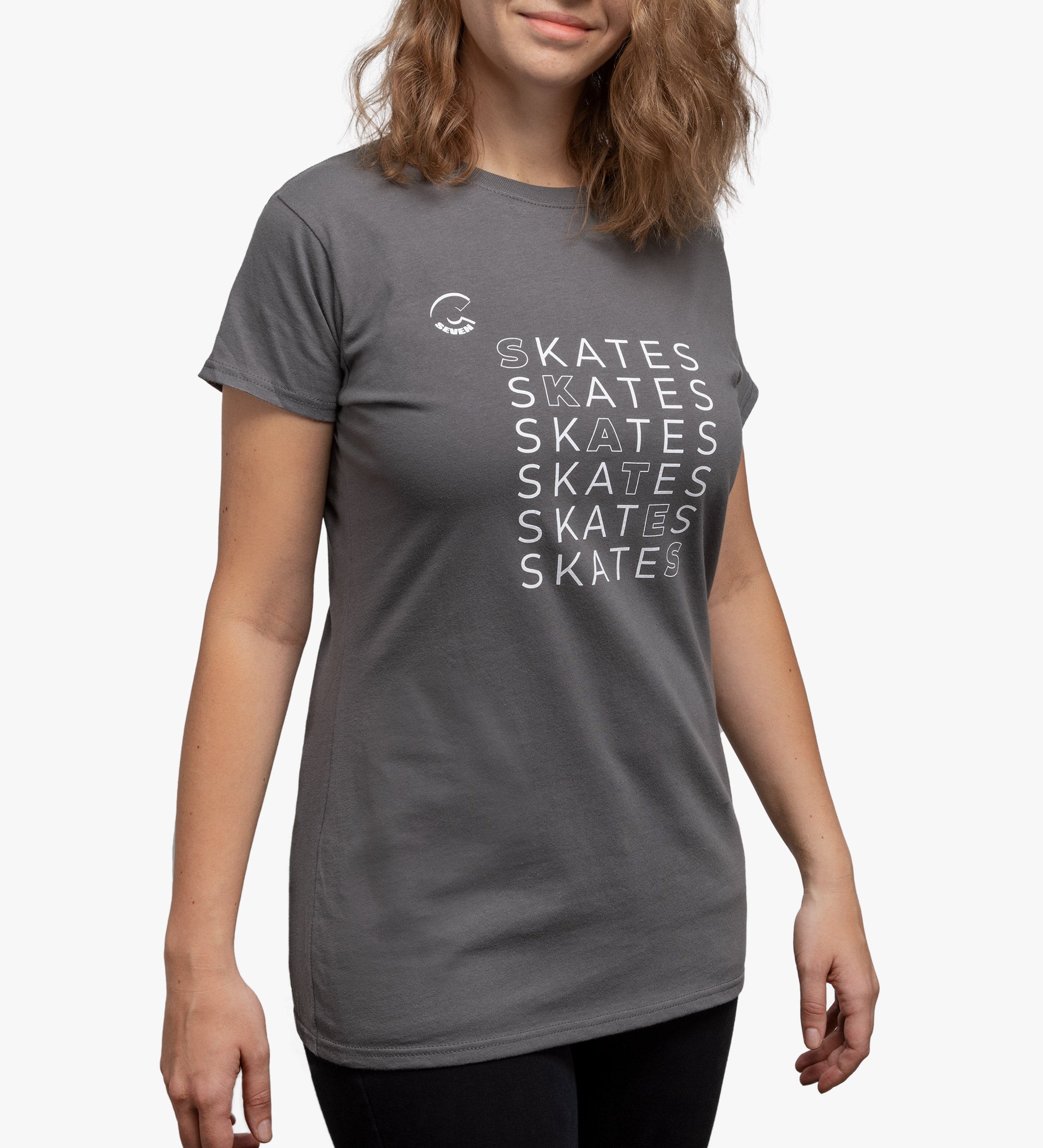 Person wearing a gray t-shirt with 'SKATES' text design on a plain background