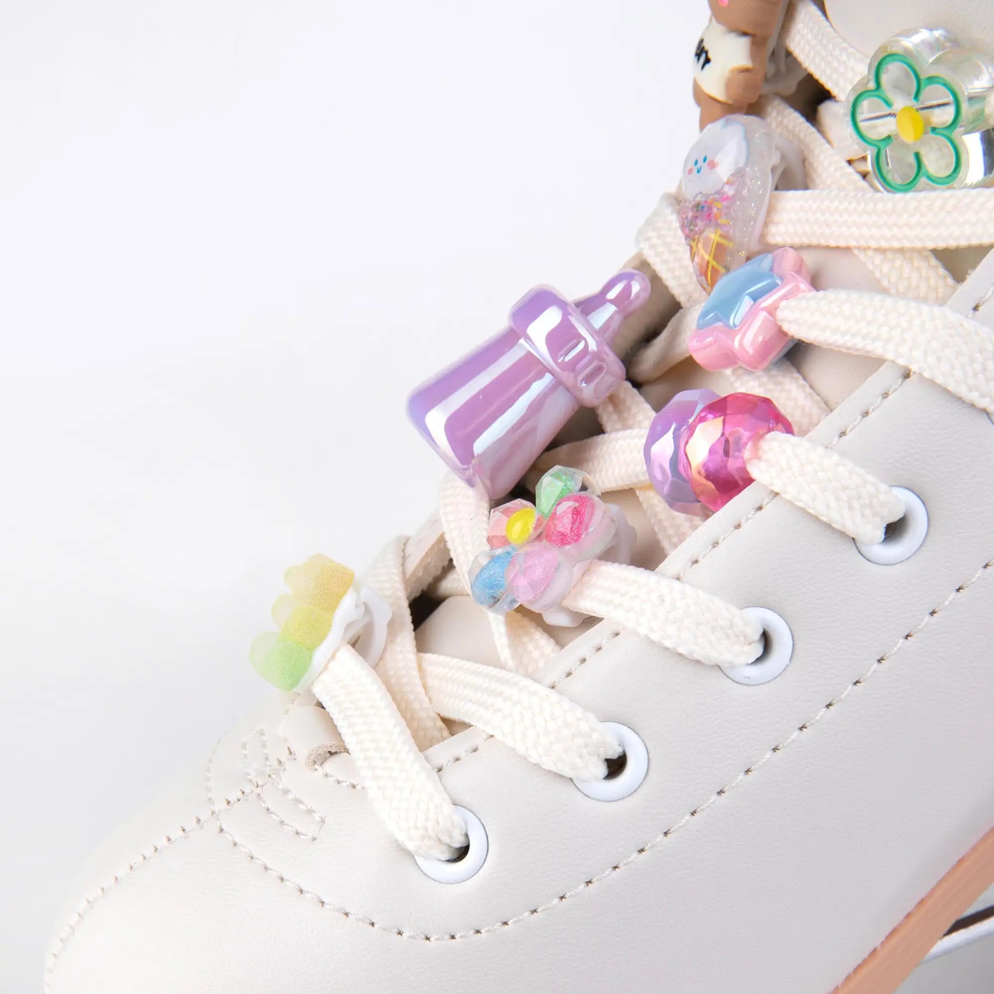 Colorful shoe charms on a white roller skates with a plain background