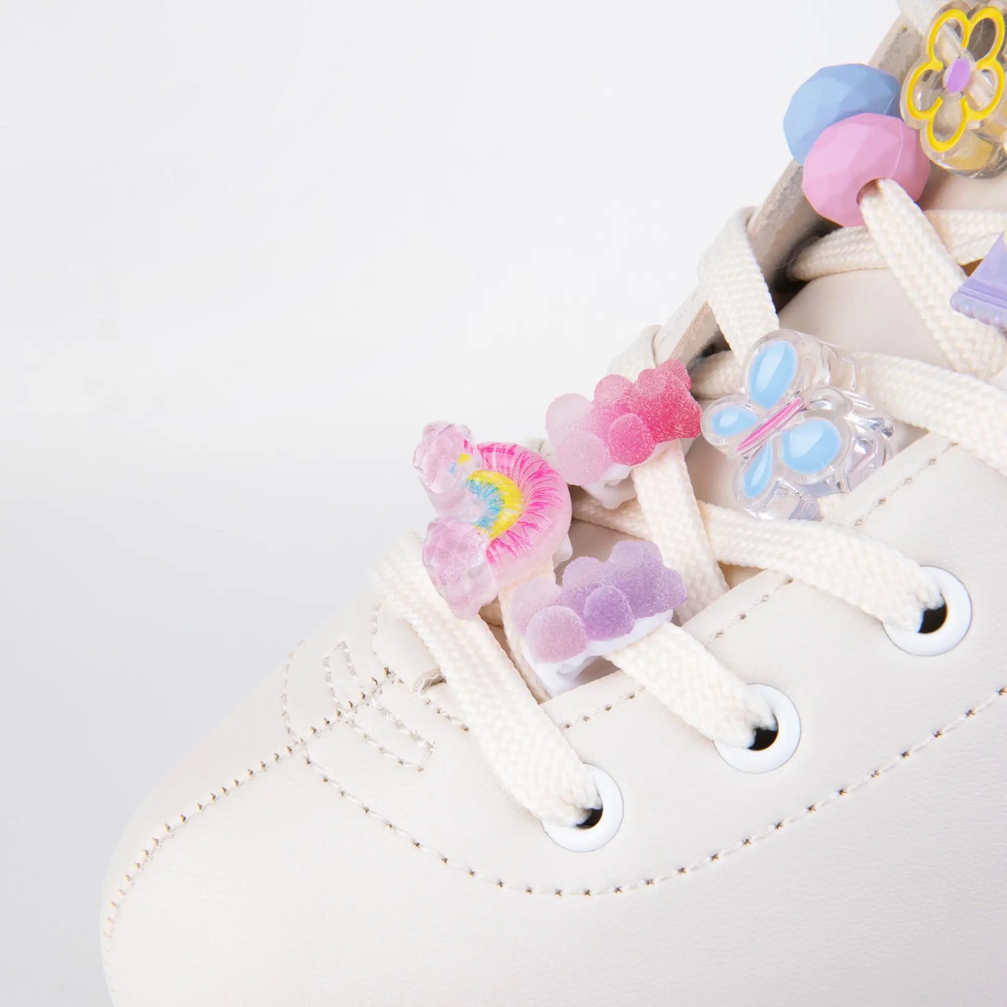 Colorful shoe lace clips on a white roller skate with a light gray background