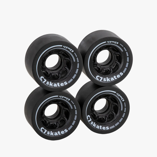 Four black C7 skates wheels on a white background