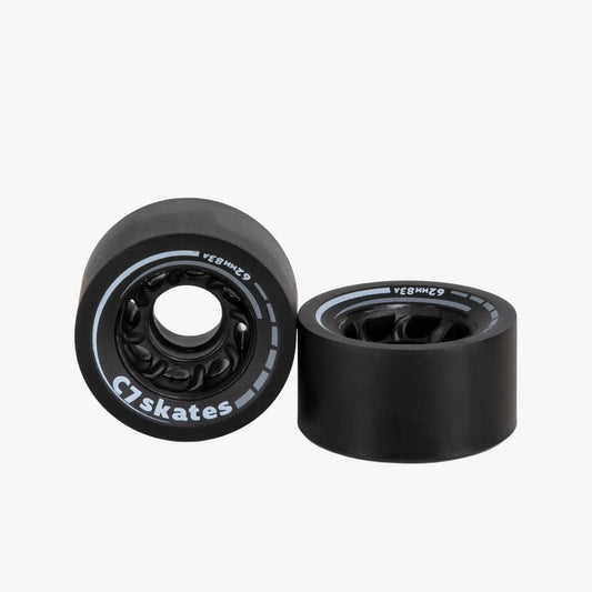 Two black roller skate wheels with bearings on a white background