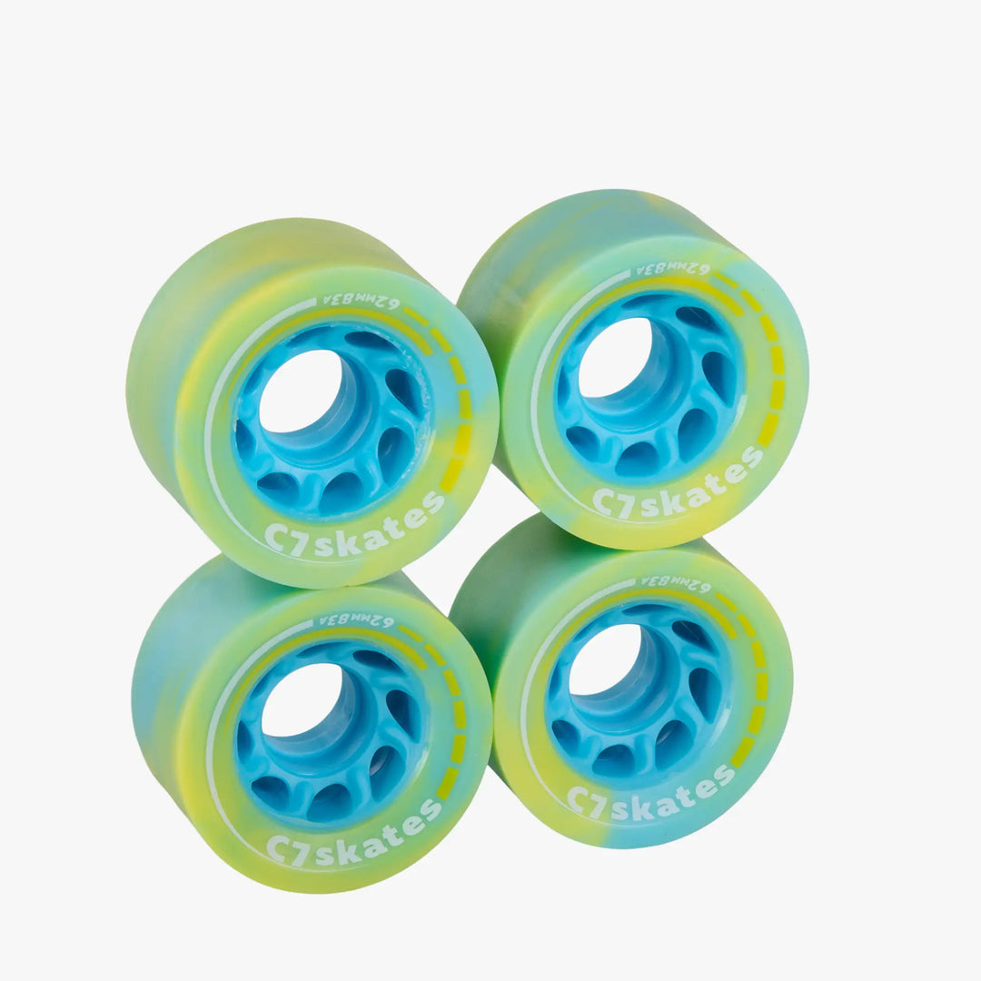 Four green and blue C7skates wheels on a white background