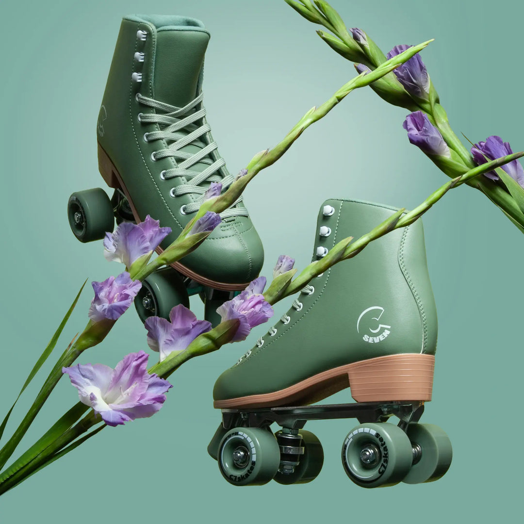 Green roller skates with brown soles featuring the brand 'C7Skates' on a light green background with purple flowers.